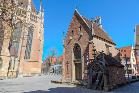HDR image of Ulm Minster, showcasing Gothic details under a clear blue sky on a sunny day. Perfect for travel, architecture, historical and inspiring design projects.の写真素材