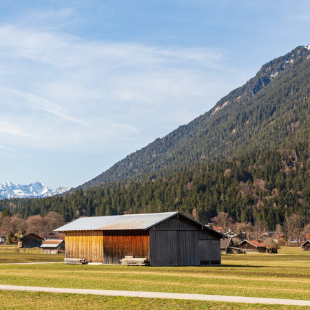 Rustic wooden barn in alpine meadow, Garmisch-Partenkirchen, Bavaria, Germanyの写真素材