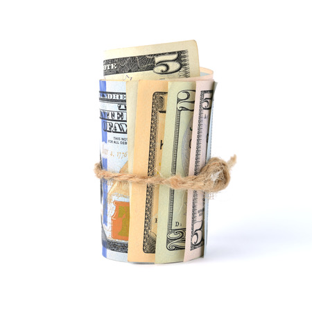 Dollar bills rolled up and tied with a rope. Isolated on white backgroundの写真素材