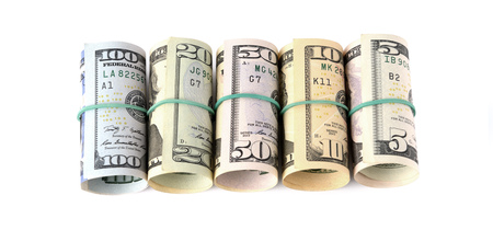 Dollar bills rolled up and tied with a rope. Isolated on white backgroundの写真素材