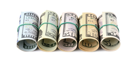 Dollar bills rolled up and tied with a rope. Isolated on white backgroundの写真素材