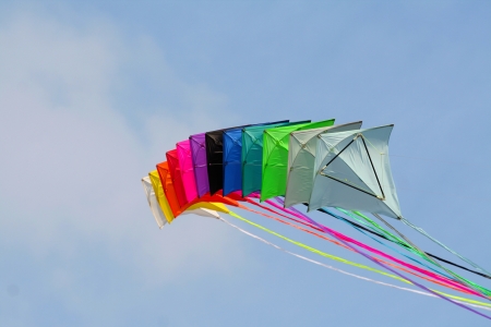 Colored kites in a blue sky, in a sunny dayの写真素材