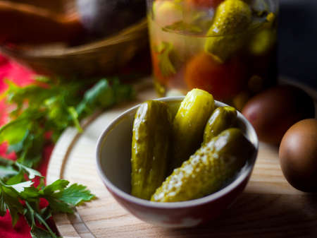 canned green pickles gherkins in a bowlの写真素材