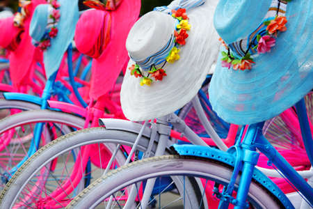front wheels of colorful bicycle and artistic hat