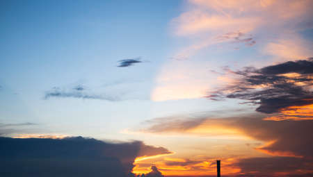 The morning sky looked like a bright golden sky. The sunrise is decorated with clouds in various shapes. Looks beautiful.の写真素材