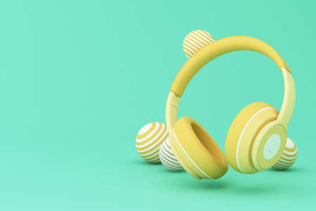 Realistic 3d render headphones with golden elements on green pastel backgroundの写真素材