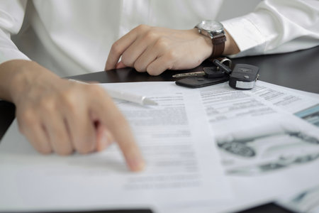 Man signing car insurance document or lease paper. Writing signature on contract or agreement....