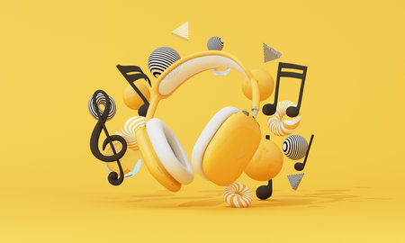 Yellow headphones with floating music notes and abstract balls on yellow backdrop. Vibrant 3d scene for audio branding and entertainment. 3d renderingの写真素材