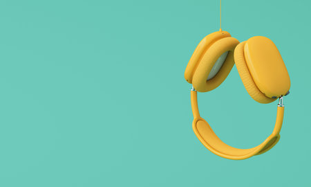 Yellow headphones hanging with cable on plain green background. Minimalist audio concept with space for text. 3d renderingの写真素材