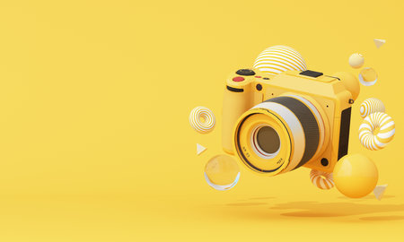 Bright yellow camera floating with playful circular and spiral elements on a soft background. Artistic and clean 3d concept. 3d rendering.の写真素材
