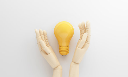 Hands supporting a yellow light bulb on white background reflect confidence in an idea strategic...