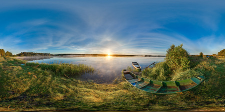 Spherical panorama. 360. Sunrise at the bank of lake. Boats on the bank of lake.