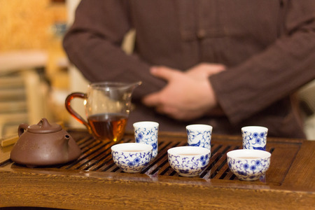 Traditional Chinese tea drinking with master on background.Traditional Chinese tea drinking ceremony.の写真素材