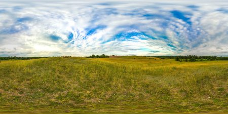 Hills. Sunset or sunrise in the green field with blue sky. Image with 3D spherical panorama with 360 viewing angle. Ready for virtual reality or VR. Full equirectangular projection. Green grass.の写真素材