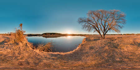 Beautiful landscape with river blue sky sunset at spring trees without greens and grass 3D spherical panorama with 360 degree viewing angle Ready for virtual reality vr Full equirectangular projectionの写真素材