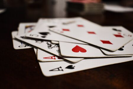 poker cards on a wood tableの写真素材