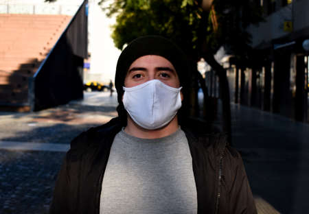 men walking around his neighborhood with a mask, in the middle of a pandemicの写真素材