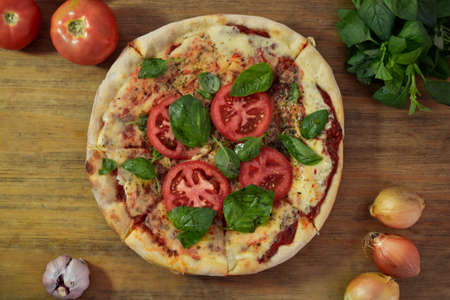pizza with tomato, basil, mozzarella, at homeの写真素材