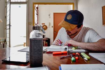 a College student working at home with books