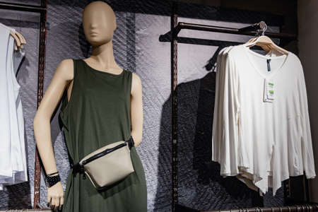 mannequin with a green dress and fanny pack, in a clothing store in Buenos Aires. Falabella