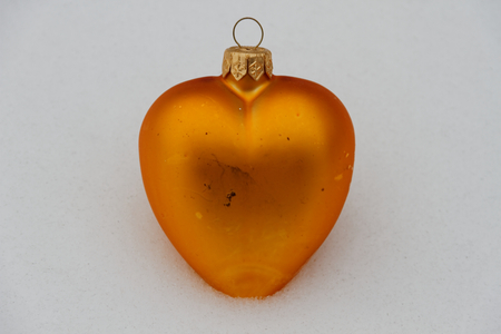 Orange heart in the snowの写真素材