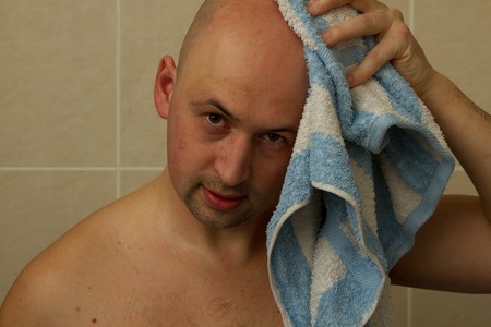 Man, wiping his head with a towelの写真素材