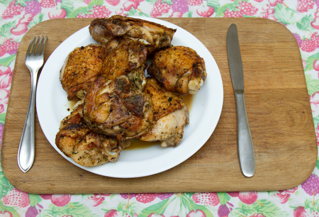 Fried chicken thighs on a white plate mealの写真素材