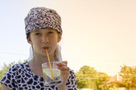 Little girl is drinking cocktailの写真素材