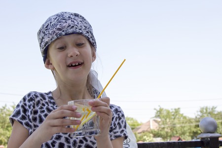 Little girl is drinking cocktailの写真素材