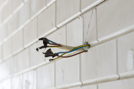 many electric wires in white wall, copyspace, selective focus.の写真素材