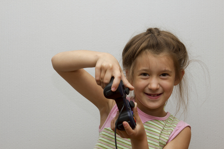 Girl using video game controllerの写真素材