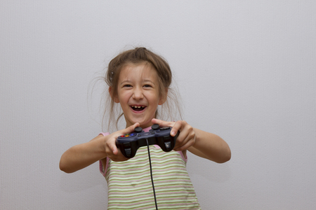 Happy Caucasian girl playing video games holding game controllerの写真素材