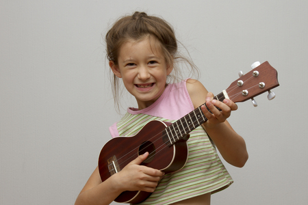 Beautiful girl playing ukuleleの写真素材