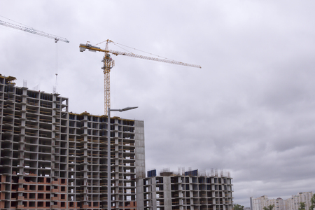Crane and building construction. New city place for many tall buildings under constructionの写真素材