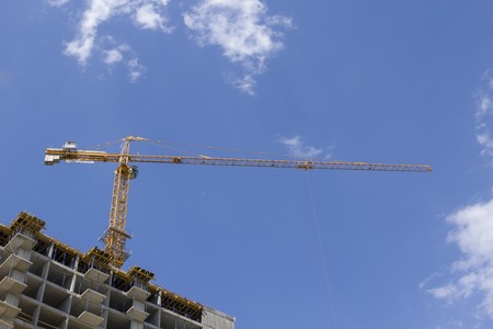 Crane and building construction on sky backgroundの写真素材