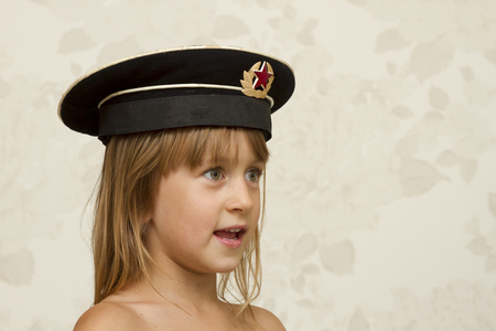 baby girl in a military capの写真素材