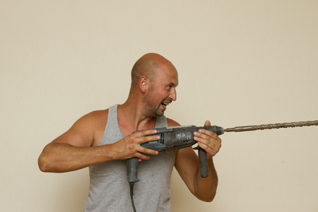 Sporty guy with with pneumatic drillの写真素材