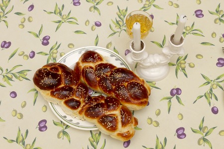 shabbat image. challah bread, shabbat wine and candles on wooden tableの写真素材