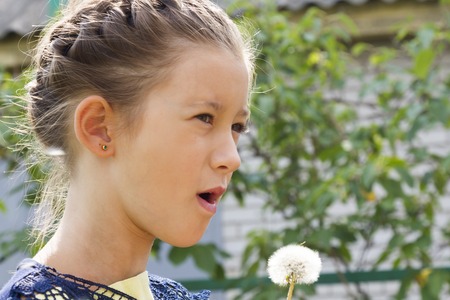 Beautiful girl with a dandelionの写真素材