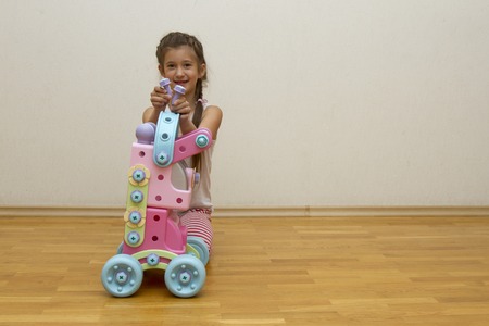 Seven-year-old girl playing with toys in the roomの写真素材