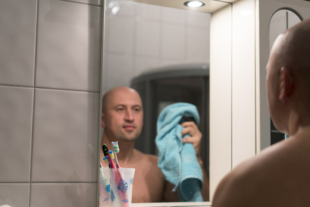 Man with a blue towel in the bathroomの写真素材