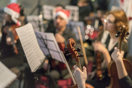 Symphony orchestra on stage, hands playing violin. Shallow depth of field, Public place.の写真素材