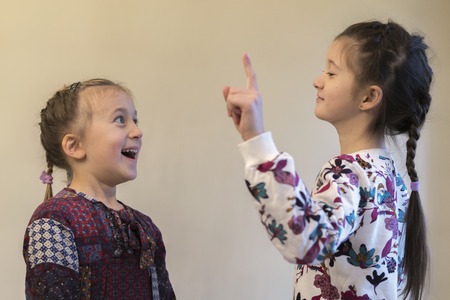 older girl explained something to little girl
