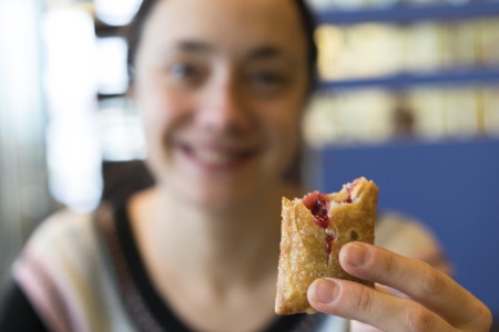 Happy girl holding a cherry pieの写真素材