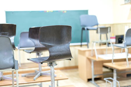 in the classroom, the chairs are on the desksの写真素材