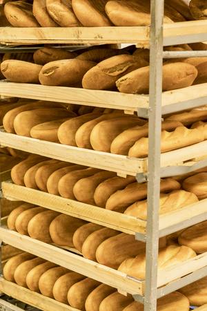 shelves with fresh bread and white bread in the mall on pallets