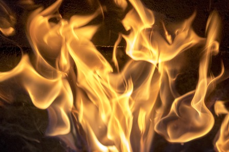 red yellow fire in the fireplace close-up. flames. Fire background