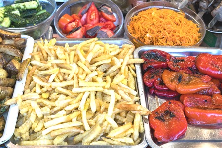 Baked vegetables, French fries. Street food