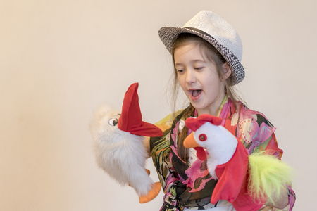 girl 8 years playing in the puppet theater. Against a light background. copy spaceの写真素材