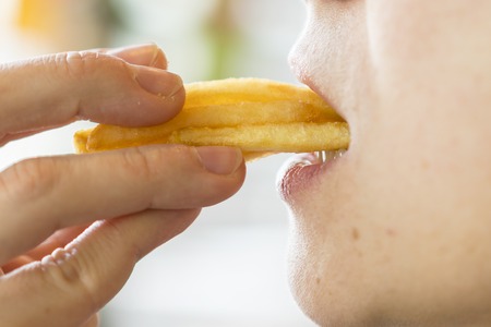 woman eating french fries. Mouth.の写真素材